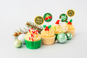 Wall Mural - Tasty Christmas cupcakes on light background