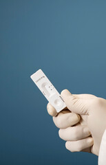 Doctor holding a test kit for viral disease tests with the COVID-19 SARS-CoV-2 laboratory card kit for the novel viral coronavirus sars cov 2 virus (formerly known as 2019-nCov)