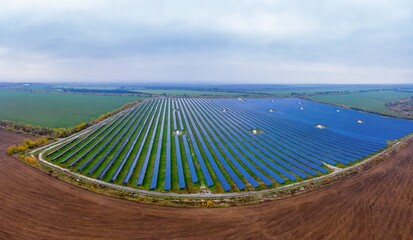 Wall Mural - Fly over a renewable solar power plant with sun in Ukraine