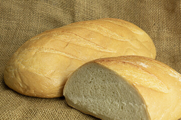 Fresh handmade bread on sackcloth background