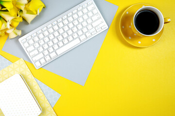 Wall Mural - 2021 colors of the year, yellow and gray, desktop workspace with keyboard and desk accessories. Top view blog hero header creative composition flat lay. Negative copy space.