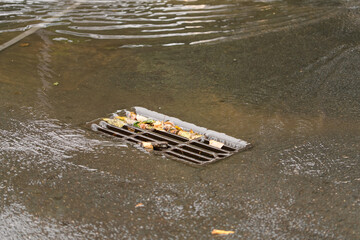 Rainwater drainage or storm grille closeup during a downpour