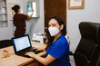 © Marcos - Latin female doctor working while sitting at desk in front of laptop in a Mexican hospital
