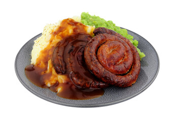 Wall Mural - Cumberland pork sausage swirl and mashed potato meal with mushy peas and gravy isolated on a white background