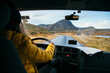 © BublikHaus - Young woman drive camping van on epic mountain road. Female adventurer travel in remote locations to camping destination. Vanlife lifestyle for urban travellers