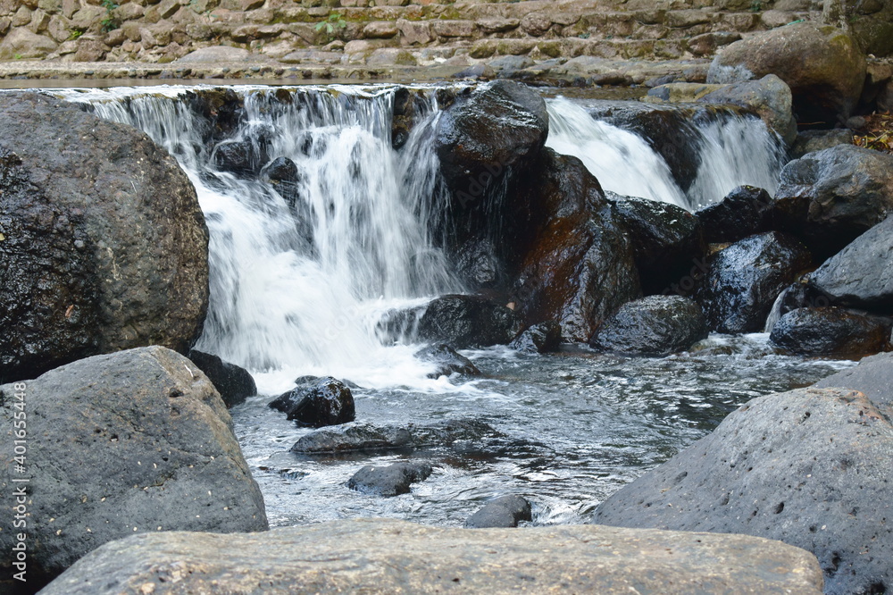 Nannu Rong water falling on river pass rock and stone at Nang Rong waterfall ...