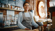 © Gorodenkoff - Beautiful Latin American Female Barista with Short Hair and Glasses is Projecting a Happy Smile in Coffee Shop Bar. Portrait of Happy Employee Behind Cozy Loft-Style Cafe Counter in Restaurant.