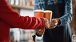 © Gorodenkoff - Shot in Modern in Cafe: Handsome Barista in Checkered Shirt Passes Two Cups of Take Away Coffee to a Young Female Customer in Red Coat. Close-up Shot with Focus on Hands.