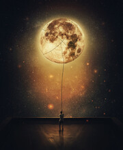Surreal Scene With A Person Stealing Moon From The Night Sky. Determined Man On The Rooftop Pulling The Full Moon Using A Rope. Overcome And Achievement Concept. Adventurer Doing A Romantic Gesture