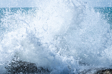 Close-up of sea waves breaking on the rocks of Vilanova y la Geltru beach