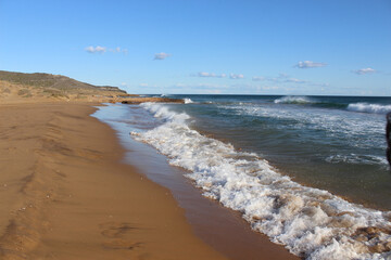 A sandy Calblanque beach on background of the blue sky