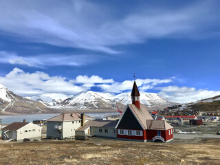 the svalbard church and surroundings in longyear town, stunning mountainscape in the background, nor