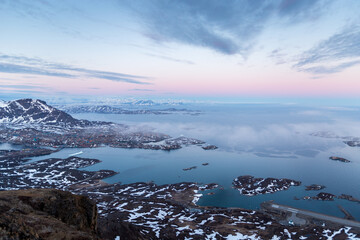 Sticker - A mesmerizing aerial shot of snowy mountains and lands near the ocean of small islands