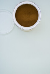 Poster - A top view shot of freshly ground coffee in a can isolated on a white background