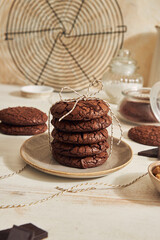 Poster - A vertical shot of delicious fudge chocolate cookie with ingredients on a white table