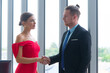 © Arunporn - Business partners success deal concept. Smart businessman and businesswoman shaking hands after success deal meeting at modern office.
