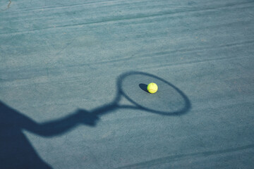 Sticker - An amazing shot of a tennis ball on the pitch with the shadow of a hand and racket on it