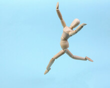 Cheerful Wooden Puppet Jumping On Blue Background