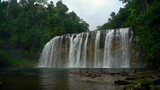 Fototapeta Kwiaty - Tinuy-an Falls waterfalls in a mountain gorge in the tropical jungle, Philippines, Mindanao. Waterfall in the tropical forest.