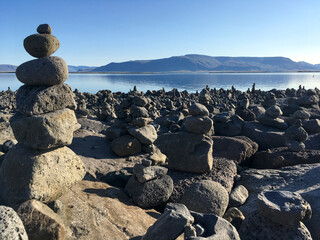 balancing stone towers on the rock beach of reykjavik Iceland
