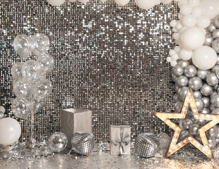 Festive silver background mosaic with light spots with silver glittering decorations. Disco balls on silver wall. Christmas, Wedding, Birthday, New Year concept. Copy space..