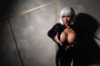 © Михаил Решетников - Sexy woman in a blonde wig and latex catsuit. Girl with big fake tits