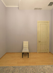 Wall Mural - white chair in an empty room with a door