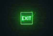 Exit Sign Light On The Wooden Wall Background.