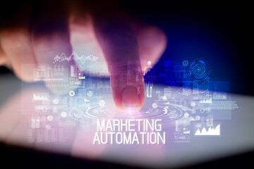 Finger touching tablet with web technology icons and MARKETING AUTOMATION inscription
