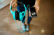 © Nomad_Soul - Girl showing headphones and phone in audio store