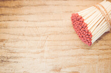 A Stack Of Matchsticks On A Wooden Surface - A Concept Of Dange