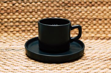 Herbal tea in black mug. Healthy herbal tea. A healthy tea in a black glass.