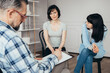 © Photographee.eu - Young daughter sits next to her mother during a meeting with therapists for teenagers with problems