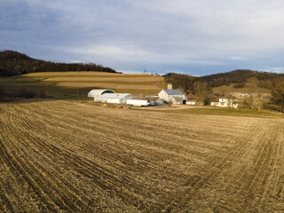 Poster - An aerial view of farmhouses near a farmland