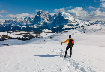 skier on the top of mountain looking at view with mountains