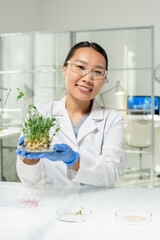 Sticker - Happy laboratory worker holding petri dish with green lab-grown soy sprouts