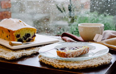 Sticker - A fresh blueberry cake served with fragrant tea on a rainy day, autumnal mood