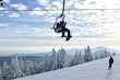 © FashionStock - Chairlift with people at Stowe Ski Resort in Vermont, view to the Mansfield mountain slopes, December fresh snow on trees early season in VT,  hi-resolution image