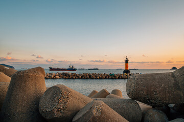 Wall Mural - Sunset of Songdo beach, lighthouse and breakwater in Busan, Korea