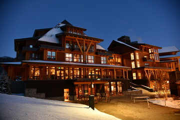 Stowe Mountain Ski Resort in Vermont, Empty Spruce peak villlage loghouses at night,  hi-resolution image