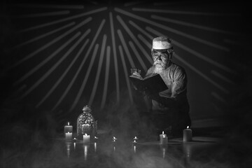 muslim man with gray beard reading islam holy al quran book