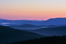 A Landscape Of Hill Silhouettes During A Sunset