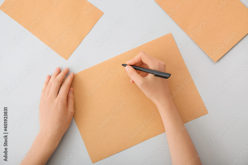 Woman with blank paper on light background