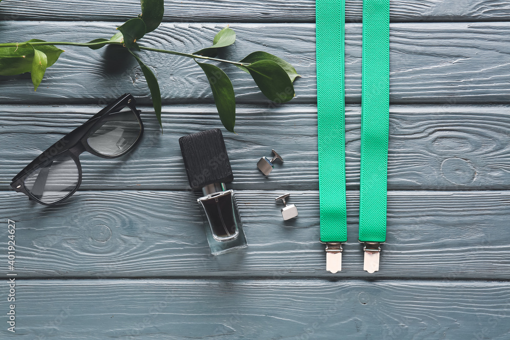 Stylish male accessories on wooden background