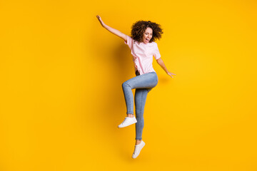 Photo portrait full body view of happy girl dancing jumping up isolated on vivid yellow colored background