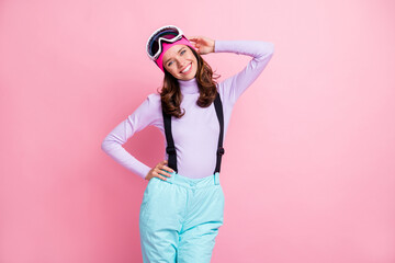 Wall Mural - Photo of adorable sweet lady snowboarder wear purple pullover headwear glasses having rest arm waist isolated pink color background