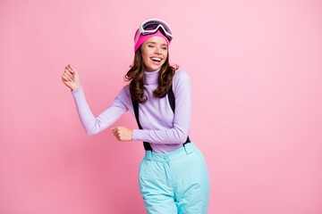 Wall Mural - Photo of sweet charming lady snowboarder wear purple pullover headwear mask glasses dancing isolated pink color background