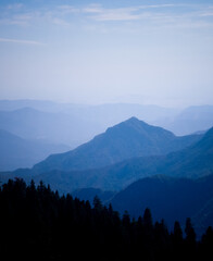 Beautiful landscape of blue mountains layers with clouds