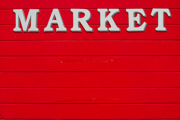 market text on red wooden wall