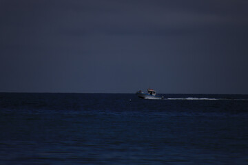 Sticker - A fishing boat on the sea on a cloudy day